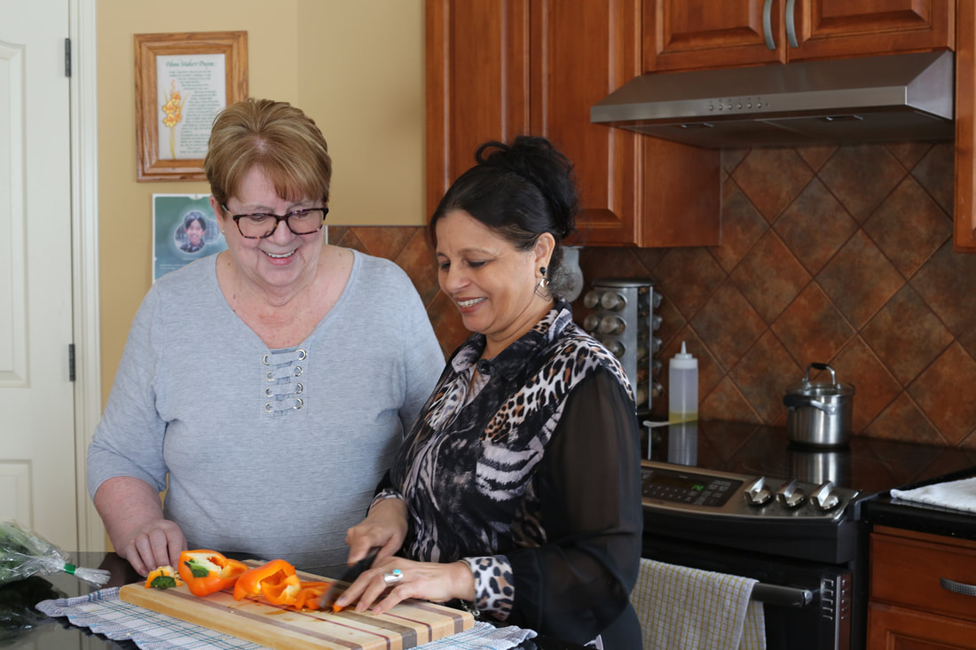 image of two seniors smiling in the kitchen